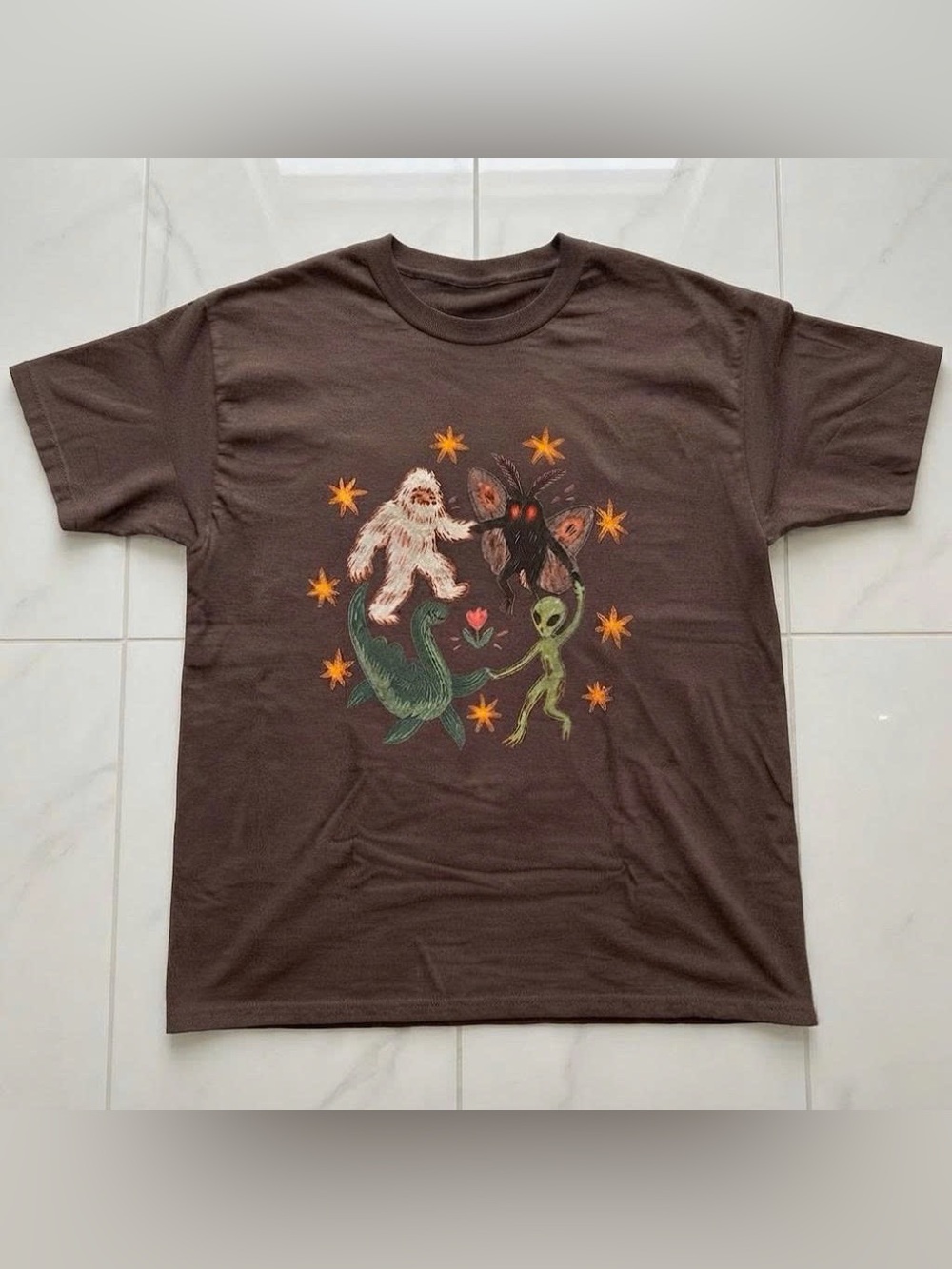 Vintage Brown Short-Sleeve Tee with Whimsical Monster Circle Graphic